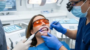 Dentist performing teeth bonding using composite resin to improve a patient's smile.